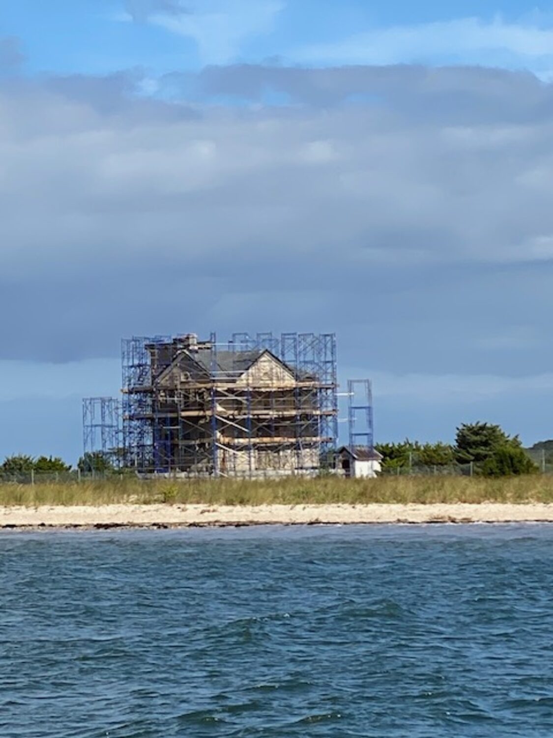 The Cedar Point Lighthouse is surrounded by scaffolding as workers start the task of repointing its stone exterior. COURTESY LEE SKOLNICK