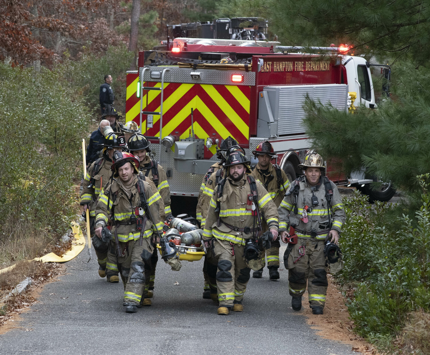 Firefighters leave the scene of a house fire on Fairmont Avenue in East Hampton Sunday afternoon. DOUG KUNTZ