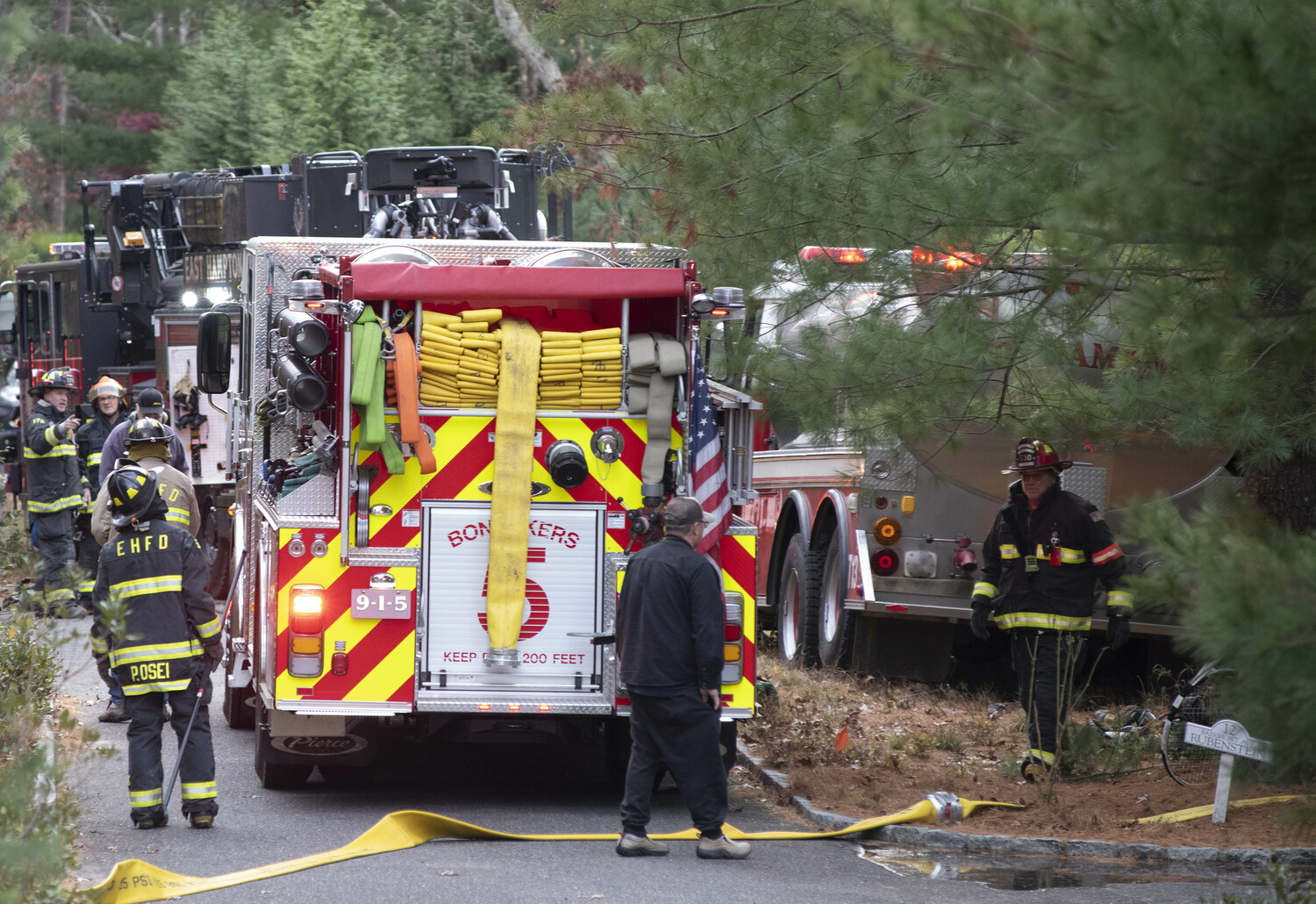 Fire trucks crowd Fairmont Avenue off Two Holes of Water Road in East Hampton Sunday afternoon as firefighters from East Hampton and three other departments battled a house fire. DOUG KUNTZ