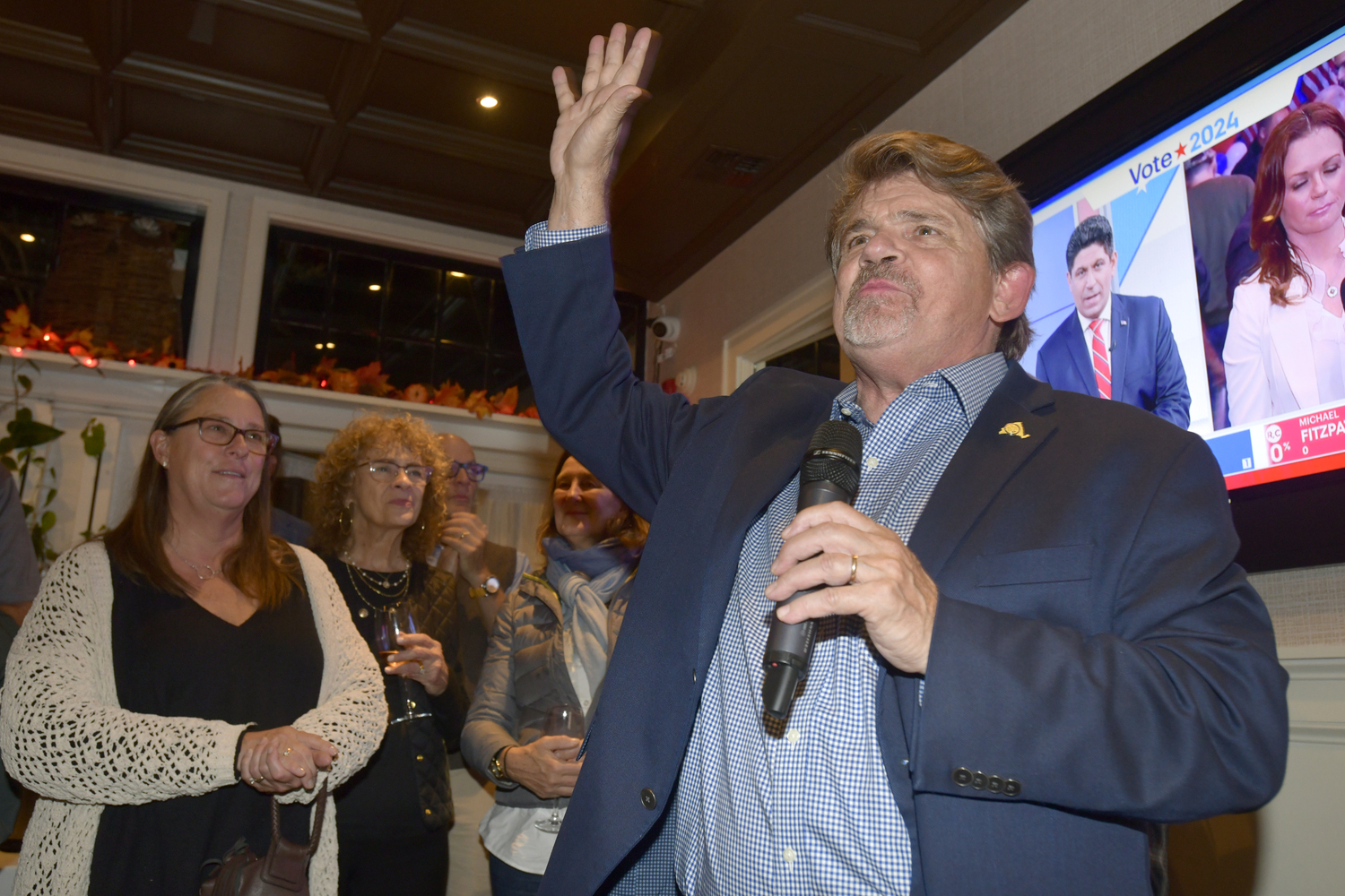 Tommy John Schiavoni, celebrates with his supporters at Page in Sag Harbor, after winning the 1st District Assembly race against Republican Stephen Kiely.  DANA SHAW