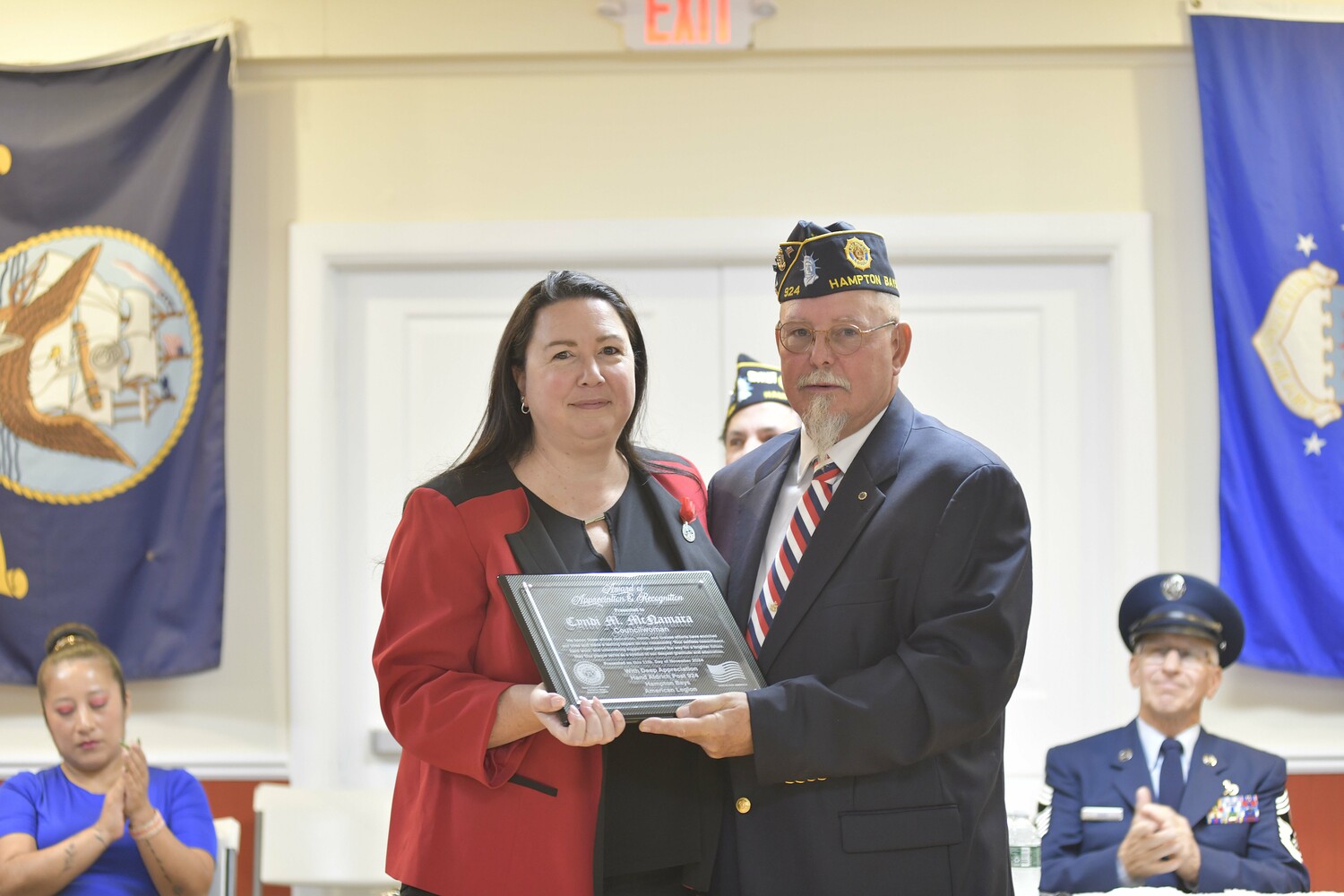 Post Commander George Hand presents Southampton Town Councilwoman Cyndi McNamara with a plaque for her dedication and work with the Legion.