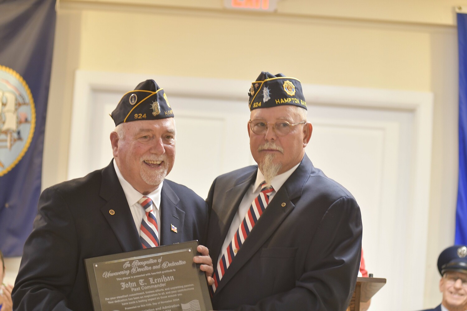 Former Post Commander John Lenihan, left, is presented with a plaque from current Commander George Hand for his accomplishments and work with the Hand Aldrich Post.