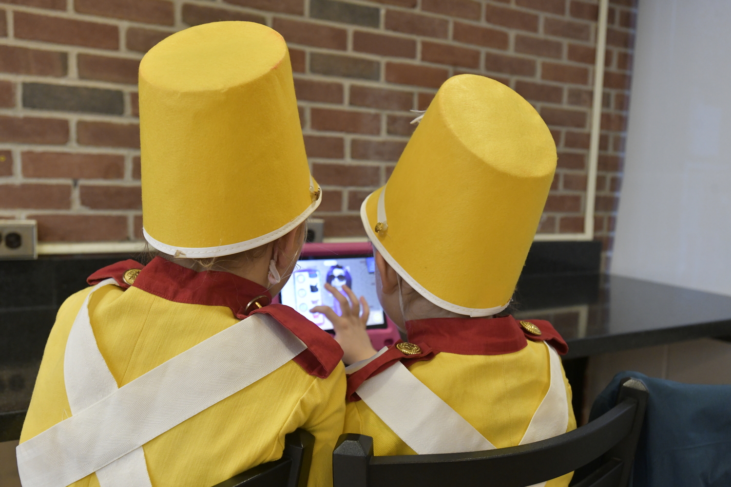 The soldiers play video games while waiting to go on.