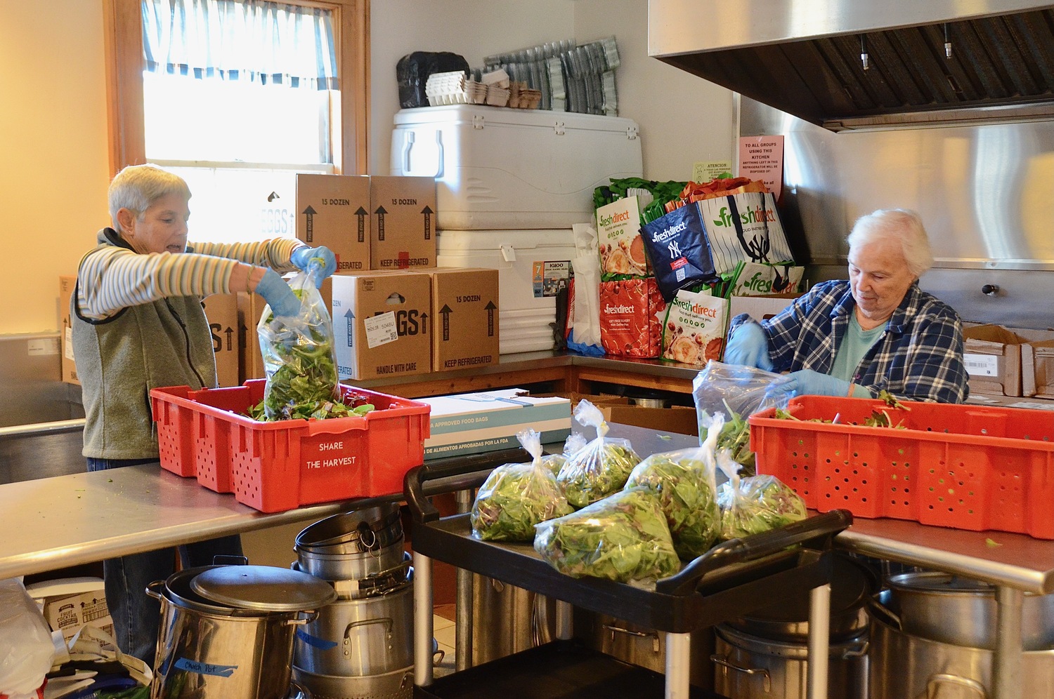 A volunteer bags greens for grocery pickup at the Springs Food Pantry. KYRIL BROMLEY