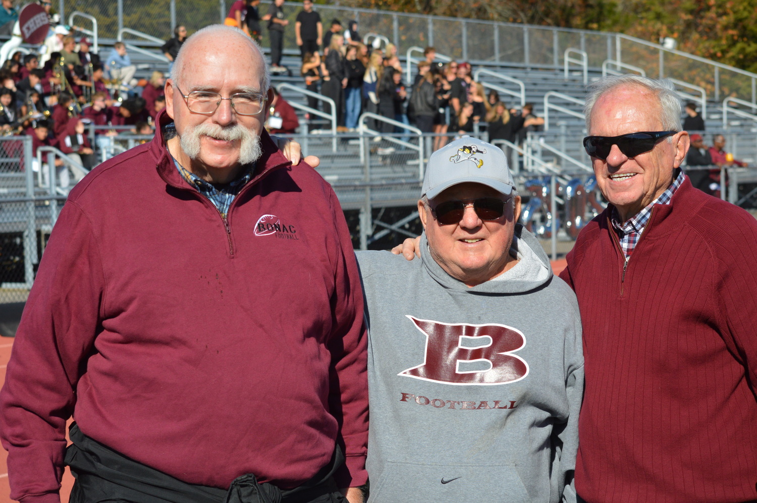 Former Bonac football coaches, from left to right, Mike Burns, Ed Budd and Dick Cooney were on hand for Saturday’s action.   GAVIN MENU