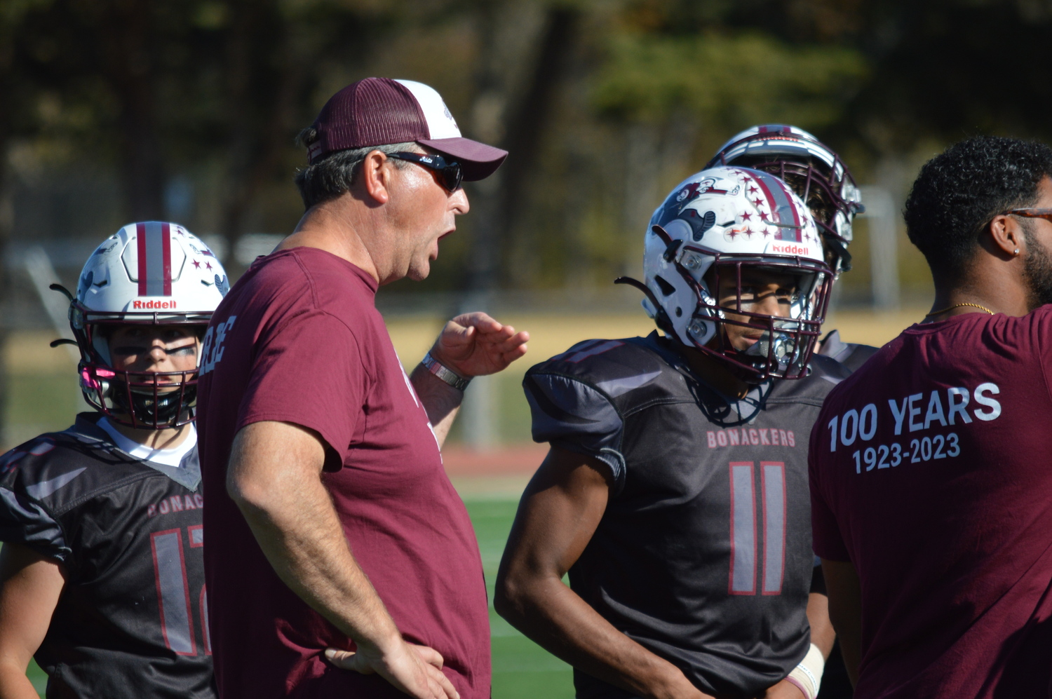 East Hampton assistant coach Jason Menu telling his lineman to stay low.   GAVIN MENU