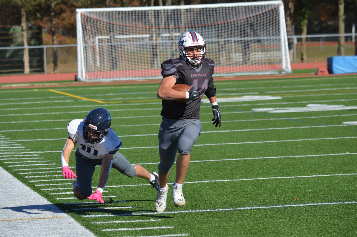 Jackson Ronick speeds past a Sharks defender on a first-quarter reception that set up East Hampton’s first touchdown.  GAVIN MENU