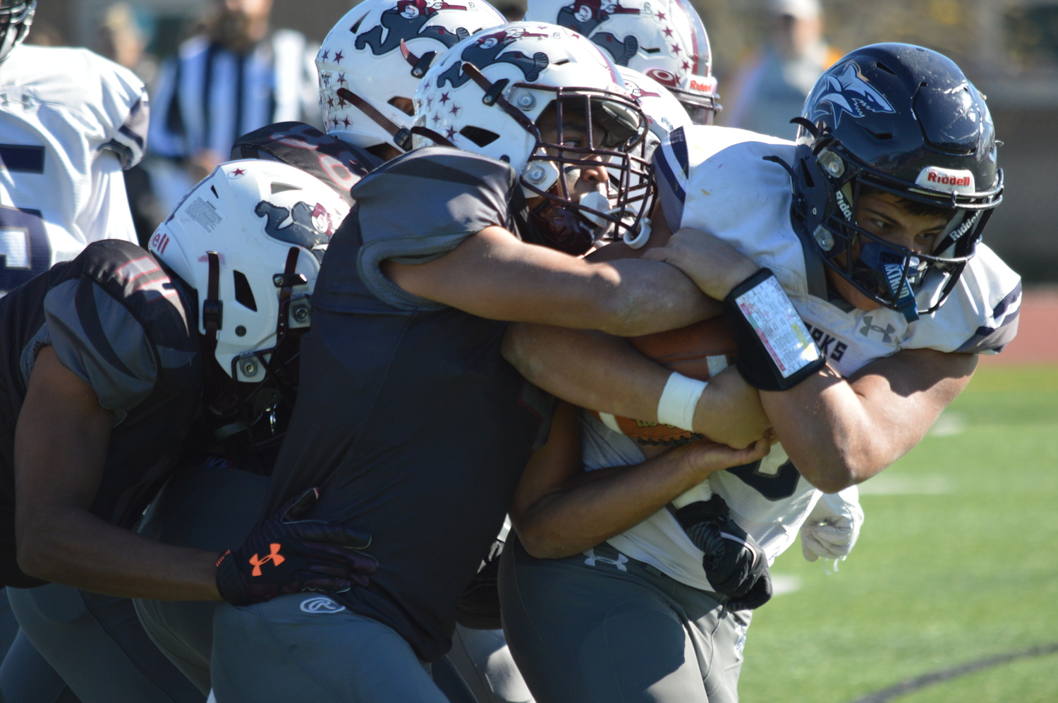 Bridgehampton junior linebacker Alex Davis leads a pack of Bonac defenders to the ball.  GAVIN MENU