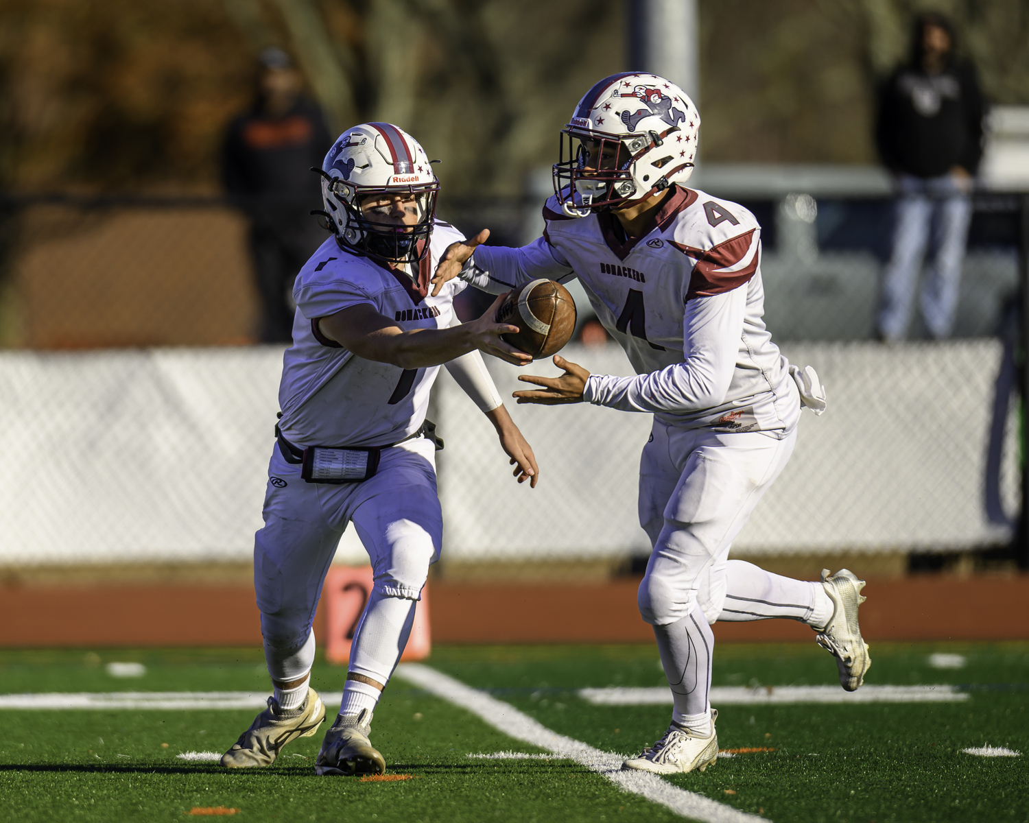 East Hampton junior quarterback Theo Ball hands off to Bridgehampton junior running back Alex Davis.   MARIANNE BARNETT