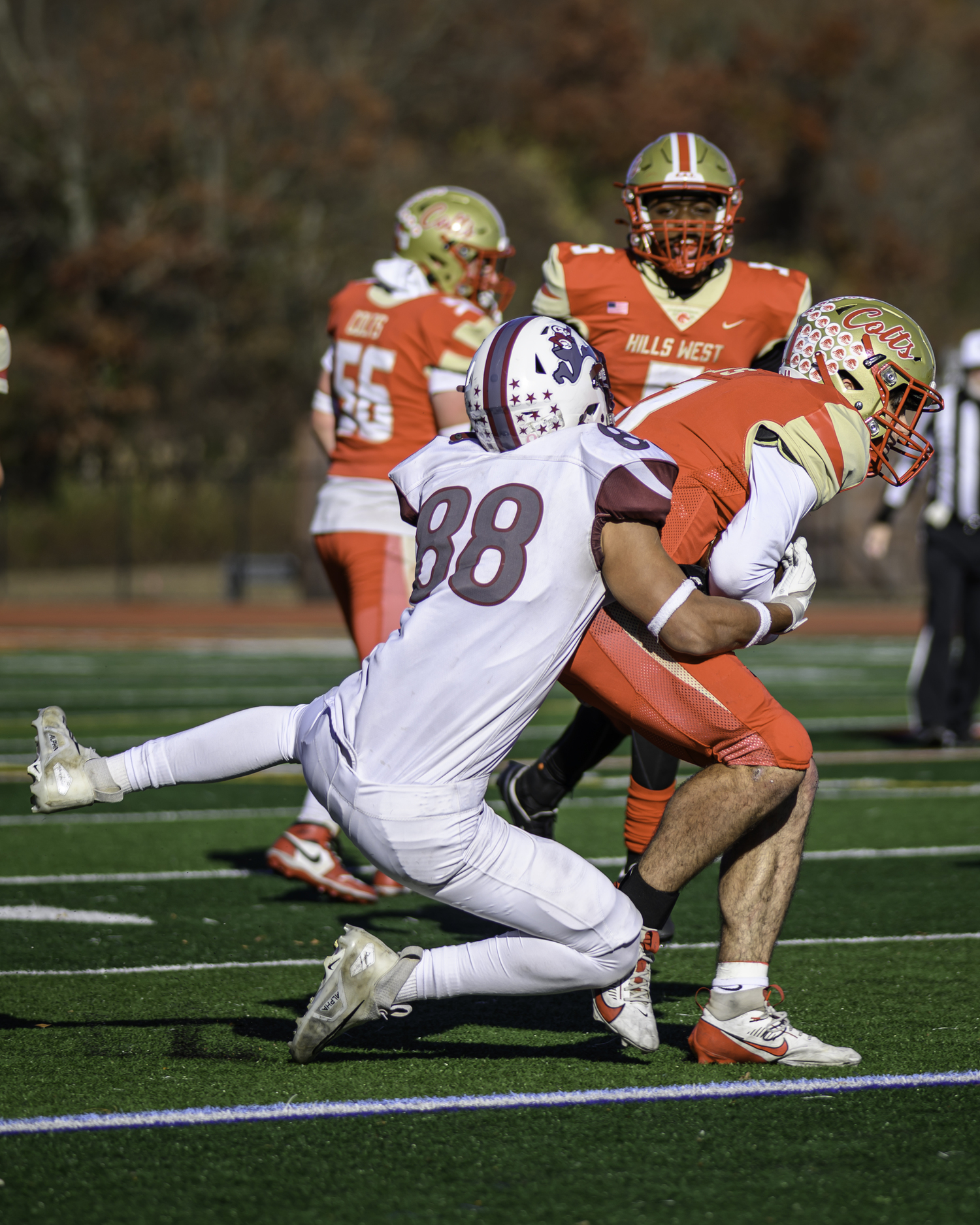 East Hampton senior Bowie Pipino takes down Hills West quarterback Joseph Filardi.   MARIANNE BARNETT