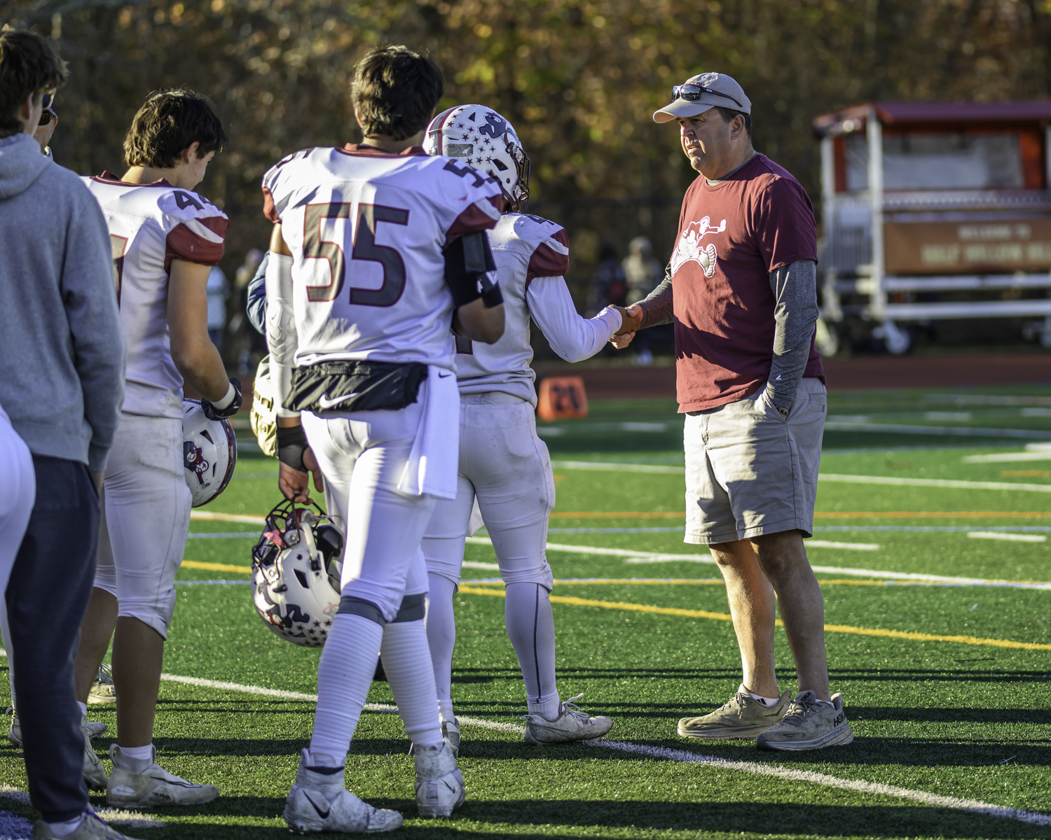 Alex Davis leads a slew of players in shaking the hand of their head coach Joe McKee.  MARIANNE BARNETT