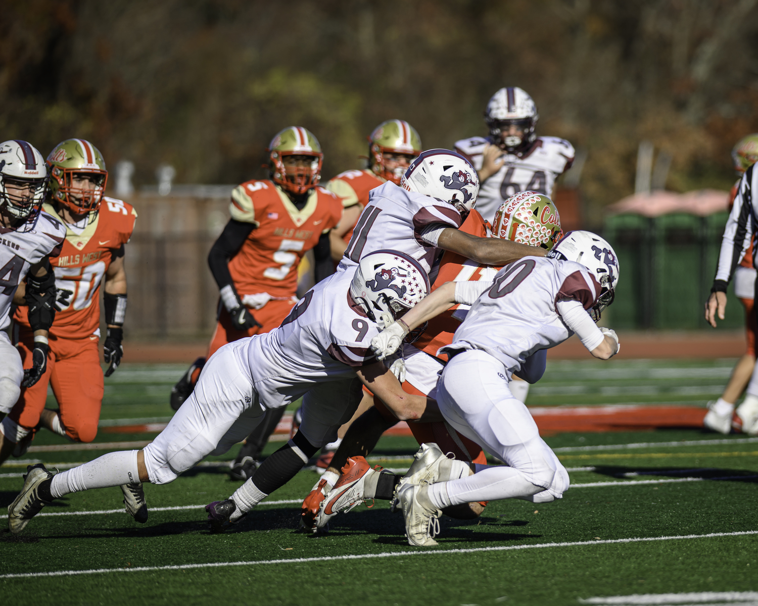 Charlie Stern (9), Jai Feaster (11) and Theo Ball (10) take down Hills West quarterback Joseph Filardi.   MARIANNE BARNETT