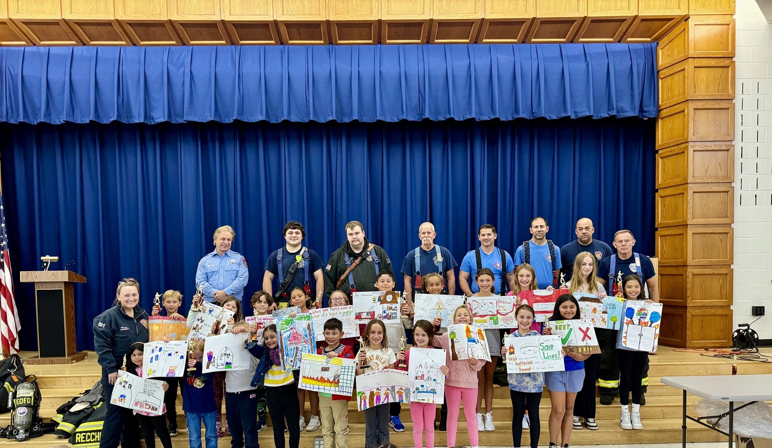 Members of the East Quogue Fire Department  with the winners of the East Quogue School’s annual fore poster contest. COURTESY EAST QUOGUE SCHOOL DISTRICT