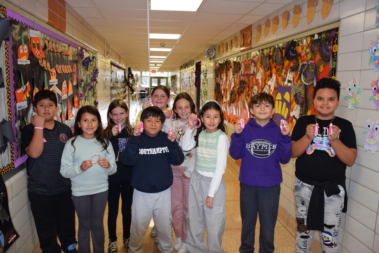 Members of the Hampton Bays Elementary School service organization K-Kids recently donated $200 to the American Cancer Society as part of their annual breast
cancer awareness fundraiser. They raised the funds by selling breast cancer awareness
bracelets and pins to fellow students, teachers and administrators. Students and staff also wore the color pink on November 1 in observance of the cause. COURTESY HAMPTON BAYS SCHOOL DISTRICT