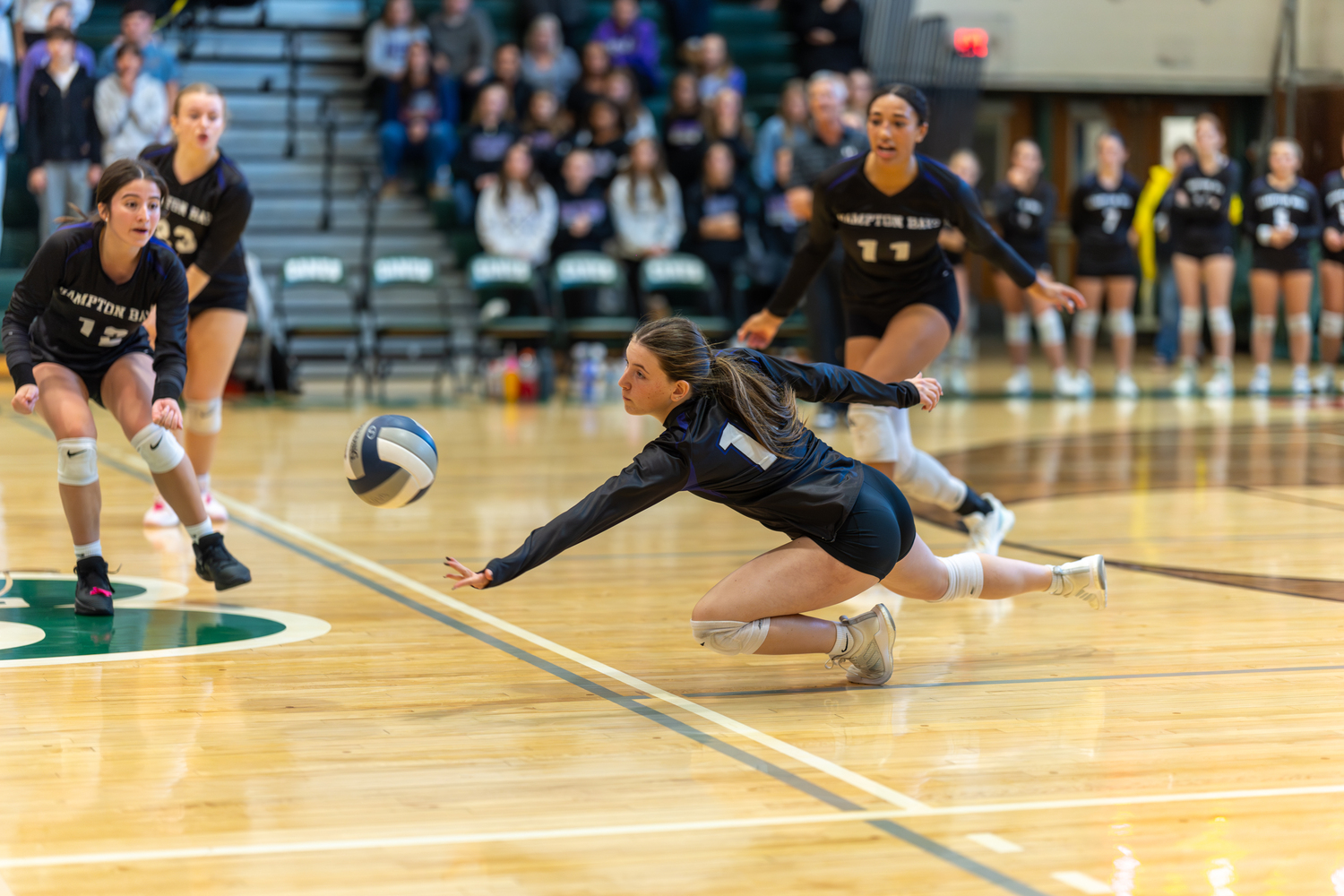 Hampton Bays junior outside hitter Lilly Maffia reaches to make a save. RON ESPOSITO