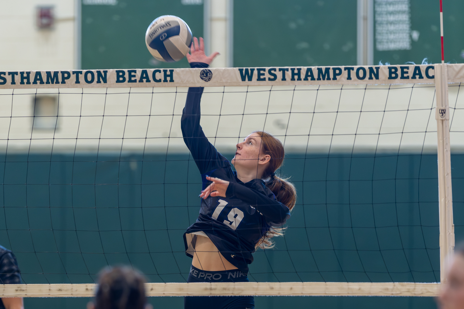 Hampton Bays junior middle blocker Shea Egan spikes the ball over the net. RON ESPOSITO