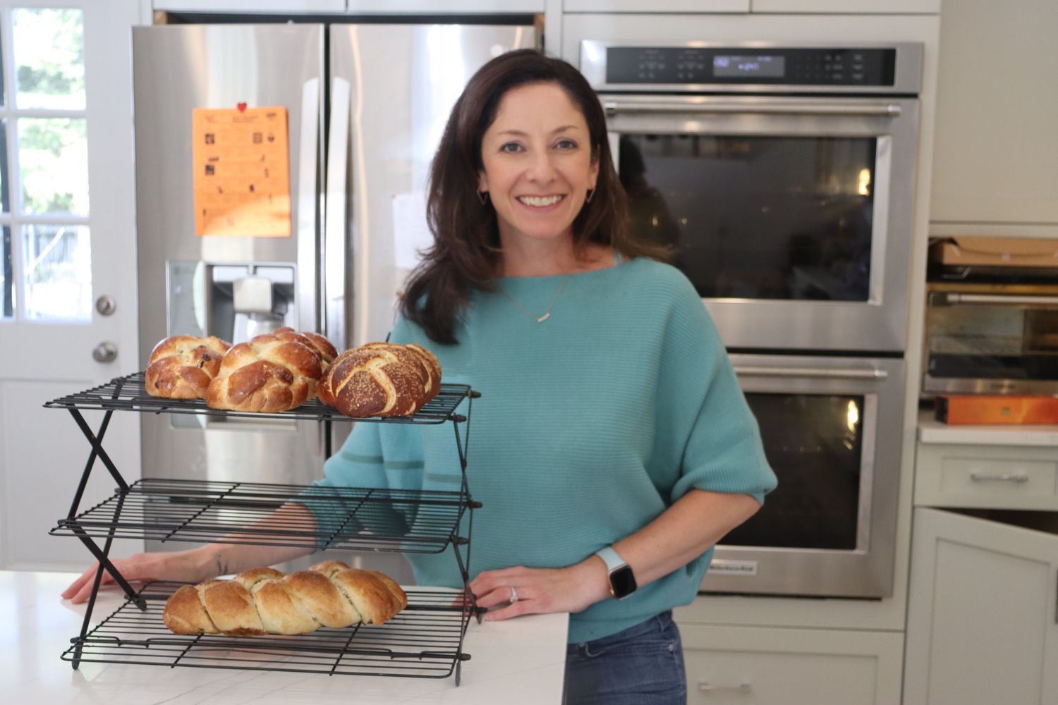 Stephanie Whitehorn with several loaves of her homemade challah bread. CAILIN RILEY