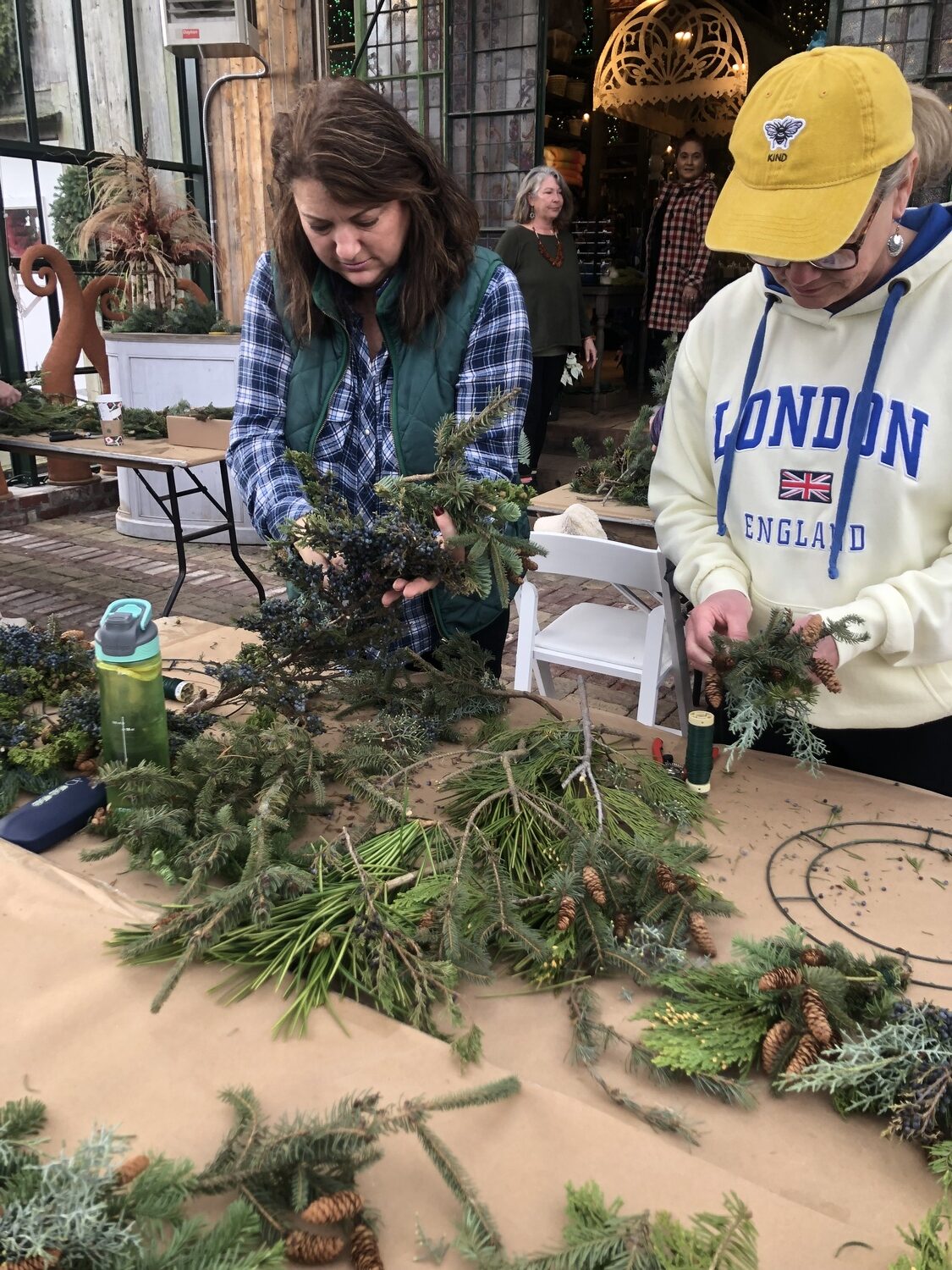 Sharon Bendzlowicz, left, and June Hamilton work on their wreaths. CAILIN RILEY