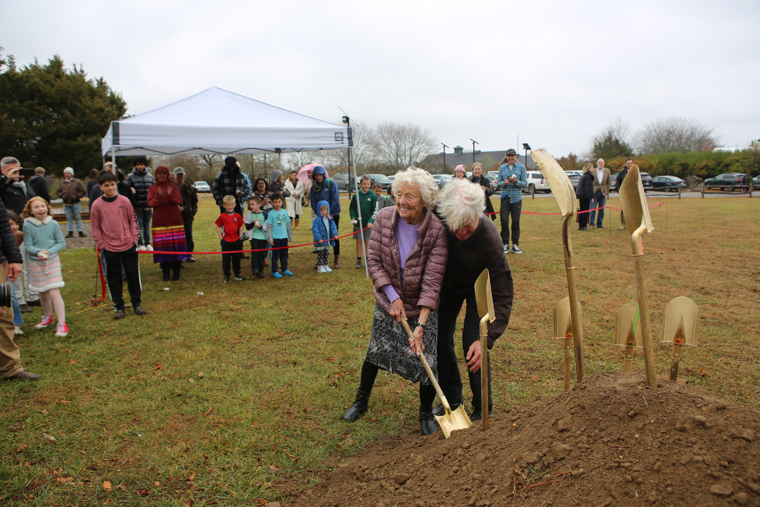 Hayground founder Tinka Topping is assisted by Jon Snow as she digs the first shovelful of soil. R.J. PARTINGTON III