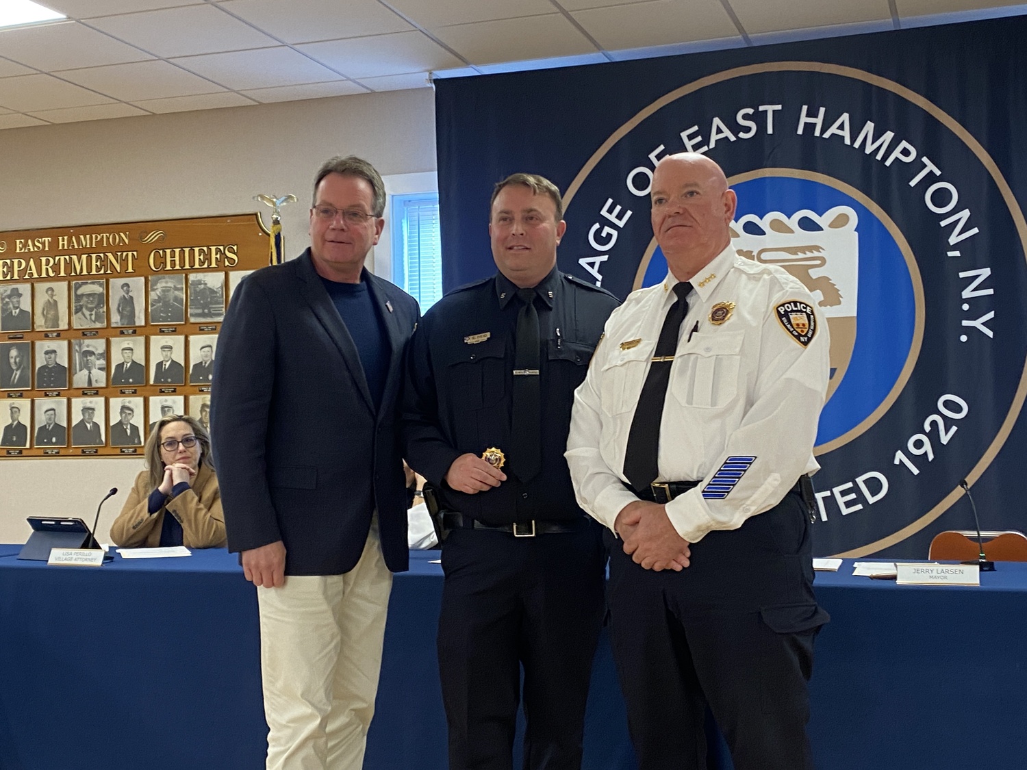 Mayor Jerry Larsen, Officer Ed Reid and Chief Jeffrey Erickson at the East Hampton Village Board's meeting on Friday, where it was announced that Reid has been promoted to detective. CHRISTOPHER WALSH