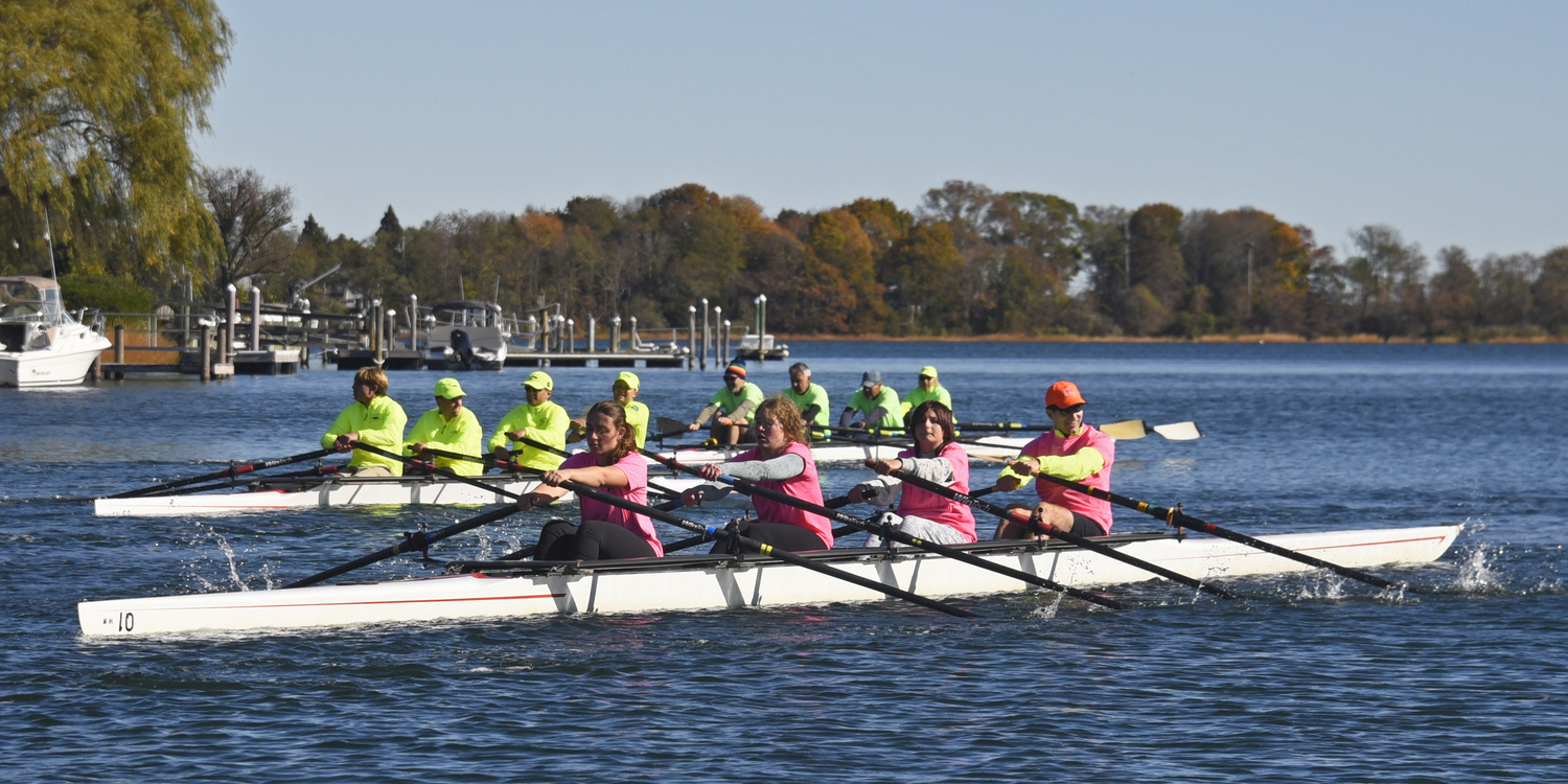 Neck and neck and giving it their all, three quad-scull teams nearing the finish line.   MICHAEL MELLA