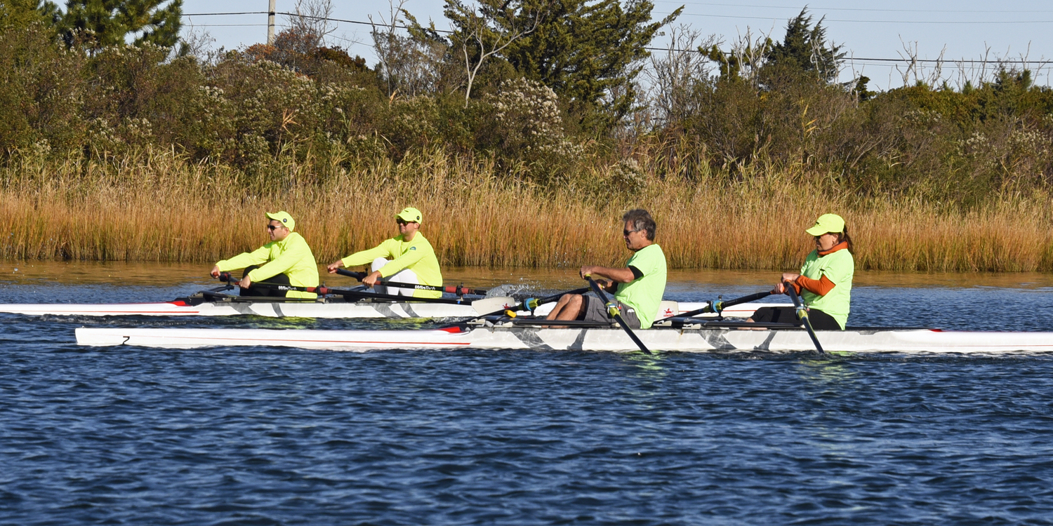 With a picture-perfect fall backdrop, Team Green is seen here edging by the Luv Michael rowers.  MICHAEL MELLA