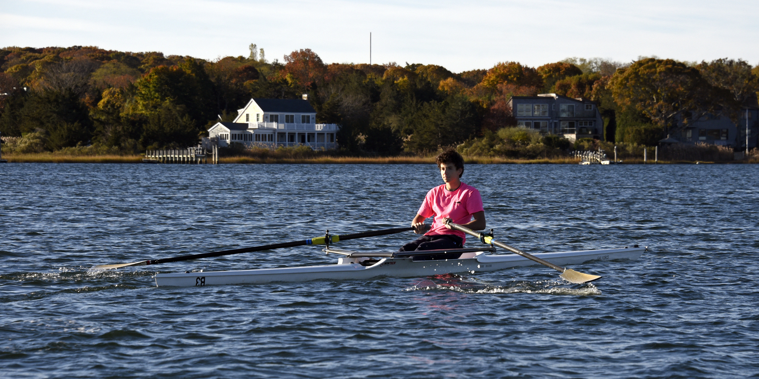 A Ross School rower showing perfect form as the sun etches out each delightful detail. MICHAEL MELLA