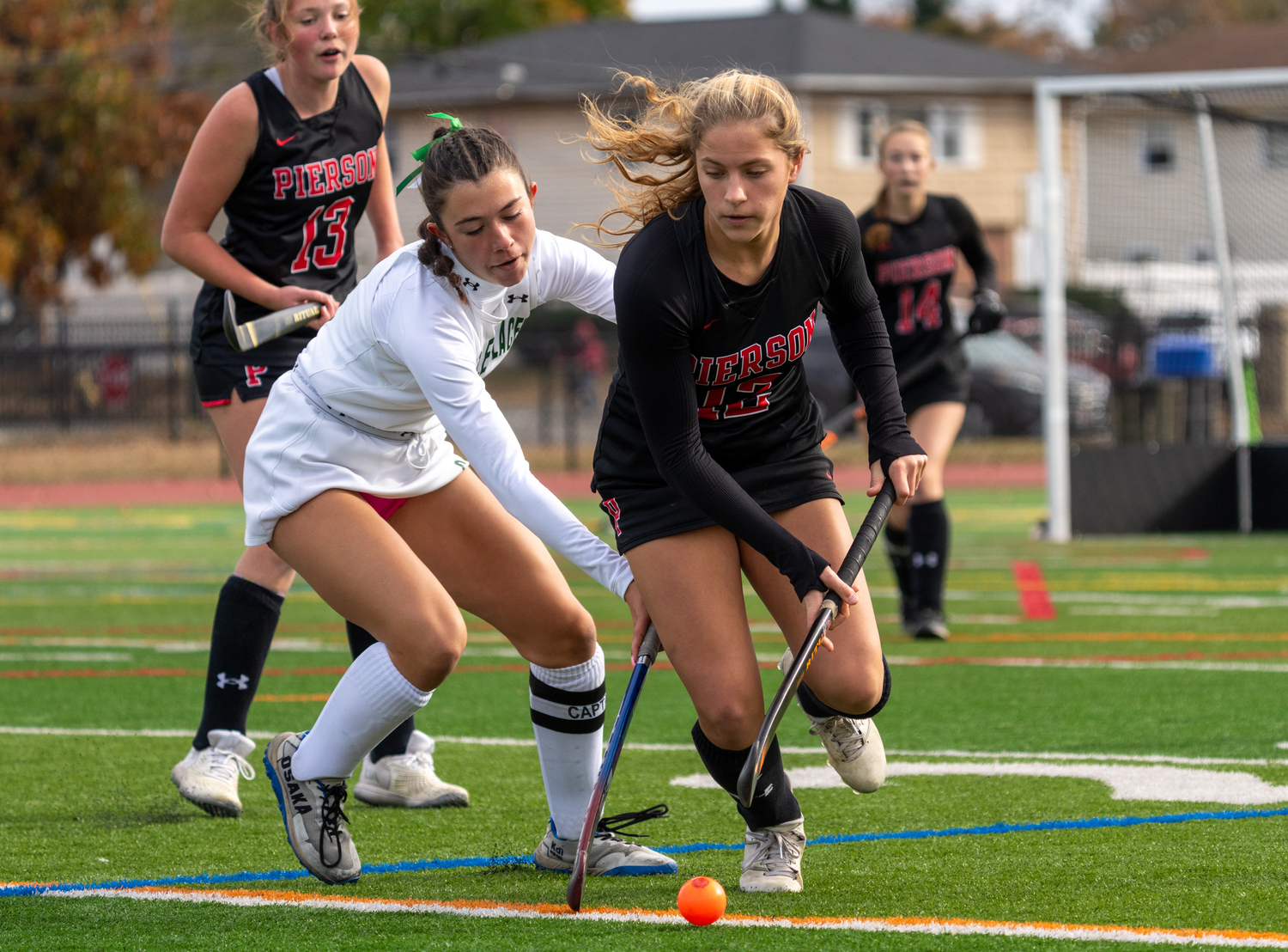 Pierson sophomore Lola Eldridge is pressured by a Carle Place player.  RON ESPOSITO