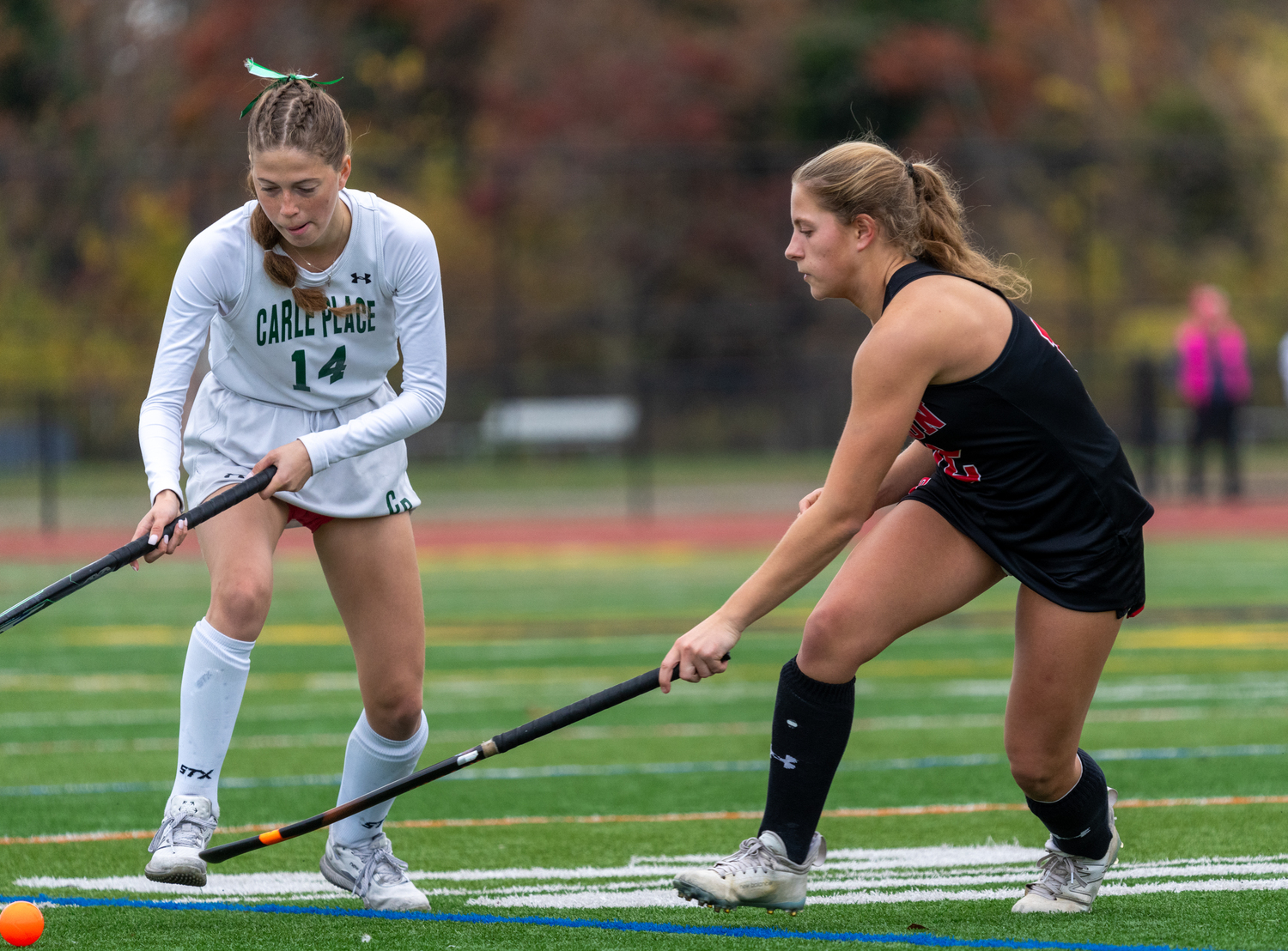 Pierson sophomore Lola Eldridge tries to poke away the ball from Carle Place senior Amanda DeMarco.   RON ESPOSITO