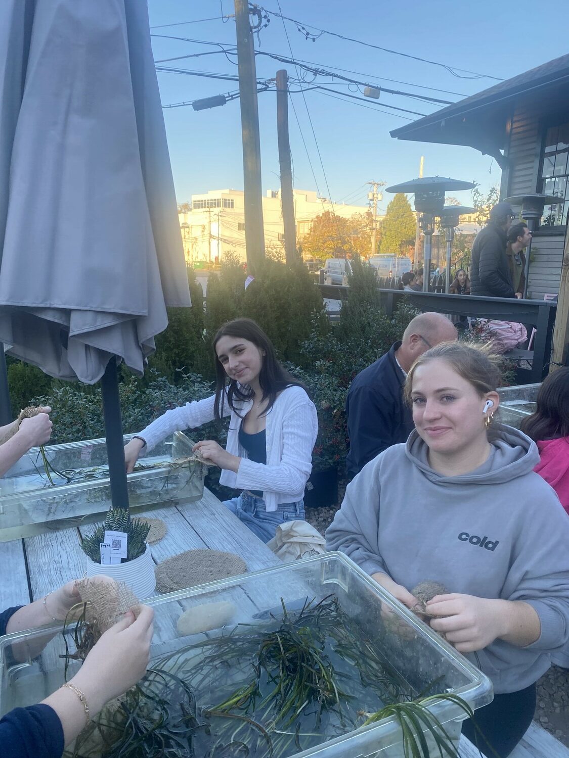 Members of the Pierson High School
Environmental Club recently gathered at Kidd Squid where they threaded native eelgrass through burlap sheets as part of a workshop
hosted by the Cornell Cooperative Extension. 
Prior to the event, students discussed the importance of eelgrass on marine
ecosystems. Native eelgrass is a vital marine plant with benefits including shoreline
protection, habitat creation and improved water quality. Members Meadow Osborn and Eva Mitchell doing their part. COURTESY SAG HARBOR SCHOOL DISTRICT