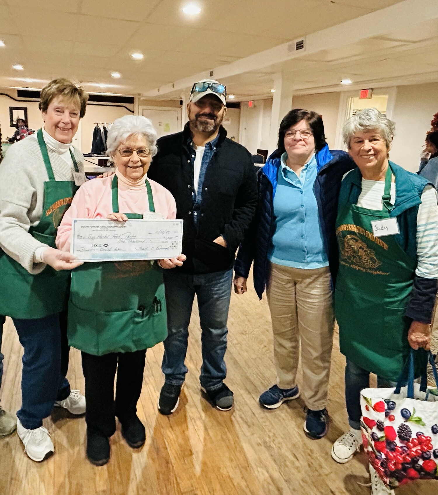 Frank Quevedo, executive director, and Melanie Meade, education director, of the South Fork Natural History Museum, visited the Sag Harbor Community Food Pantry to present Evie Ramunno, executive director of the pantry, with a $1,000 donation to be used during the upcoming holiday season at the pantry.  From left, Kate Robertson, president Sag Harbor Community Food Pantry Board, Evie Ramunno, Frank Quevedo, Melanie Meade, and Judy Lattanzio, pantry volunteer. COURTESY SAG HARBOR FOOD PANTRY