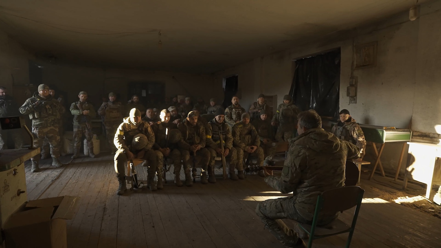 Mykolai Sierga sings and plays guitar for soldiers on the frontline. ARTEM POZNANSKYI