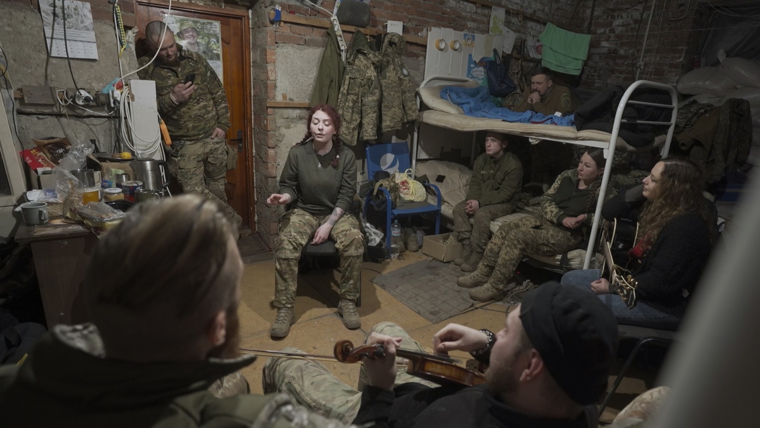 Ptashka from Azovstal, a medic and singer, performs for her battalion. ARTEM POZNANSKYI