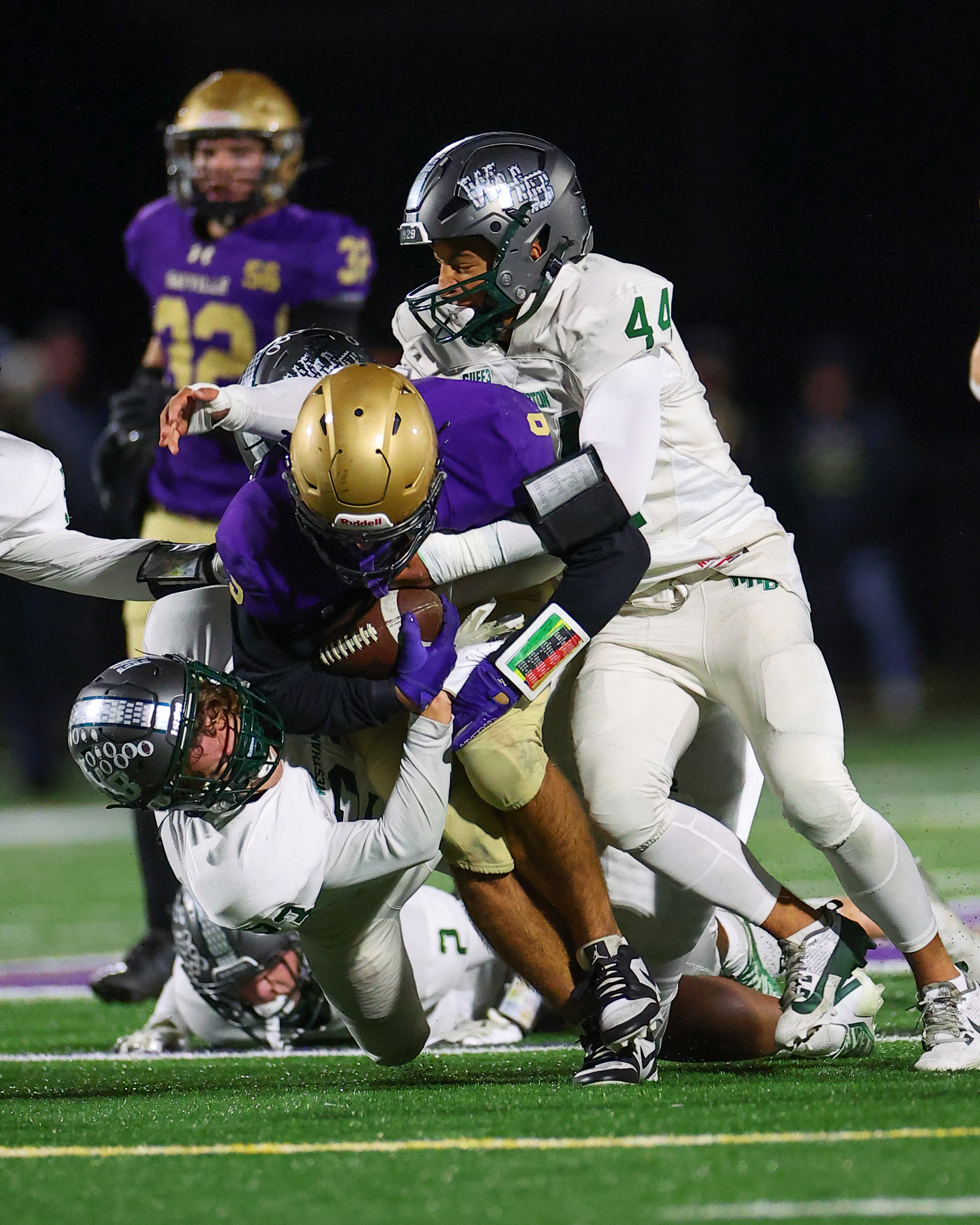 Huccricanes Patrick Fay and Aidan Arrasate tackle Sayville's Kyle Messina.   TIMOTHY BUTLER