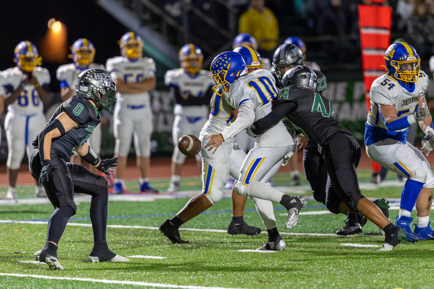 Westhampton Beach senior Aidan Arrasate hits Comsewogue quarterback Nick Saladino and the ball pops out.   RON ESPOSITO