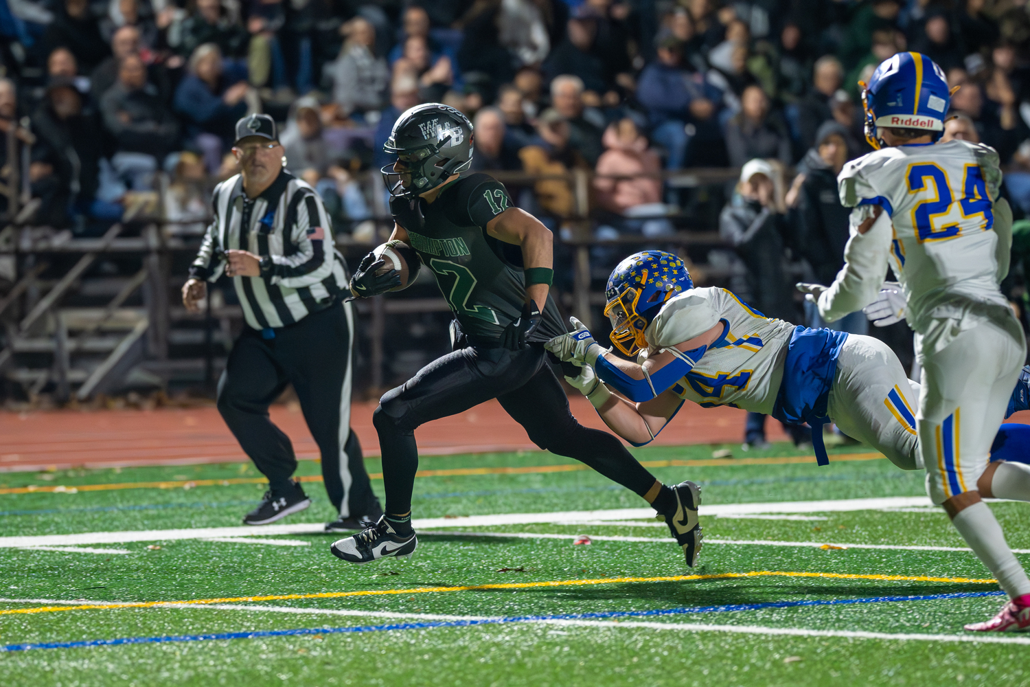 Westhampton Beach senior Brody Schaffer tries to break loose of a Comsewogue defender's grasp.   RON ESPOSITO