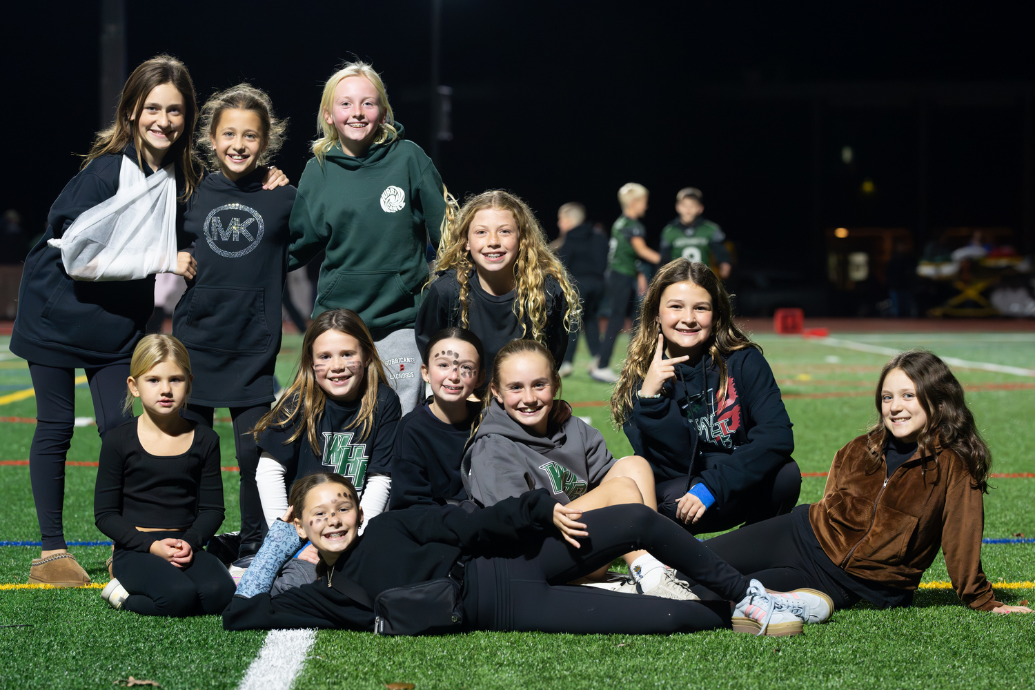 An open field at halftime during Friday night's varsity football game at Westhampton Beach drew a group of not-so-camera shy girls. RON ESPOSITO