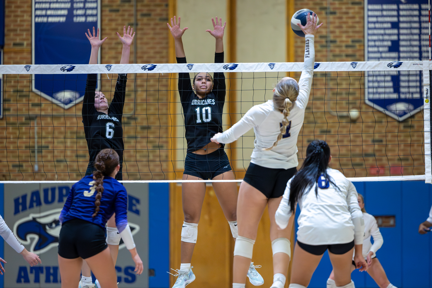 Senior middle blocker Karly Pascale and junior outside hitter Jasmine Taylor leap for a block. RON ESPOSITO