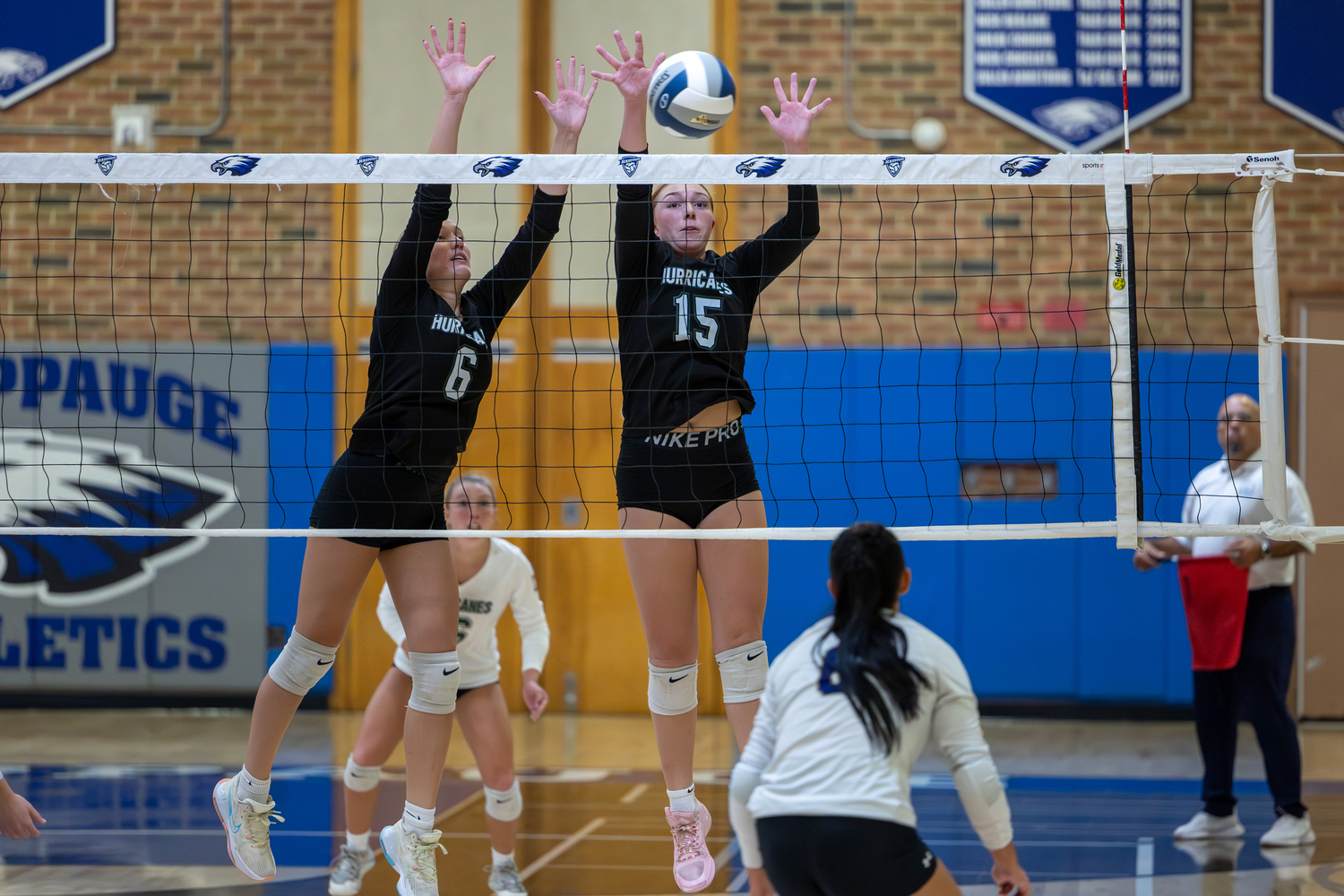 Senior middle blocker Karly Pascale and junior outside hitter Katie Burke reach for the ball. RON ESPOSITO