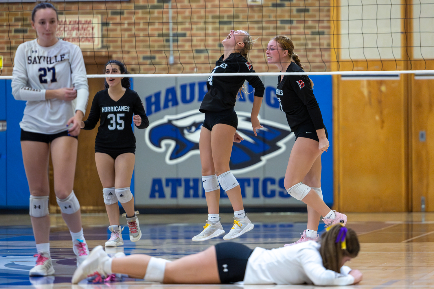 Senior middle blocker Shannon Sweet, at center, celebrates a point with senior Makayla Vignieri and junior Katie Burke. RON ESPOSITO