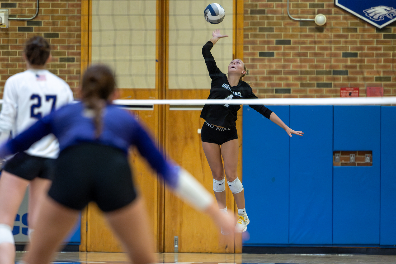 Senior middle blocker Shannon Sweet serves. RON ESPOSITO