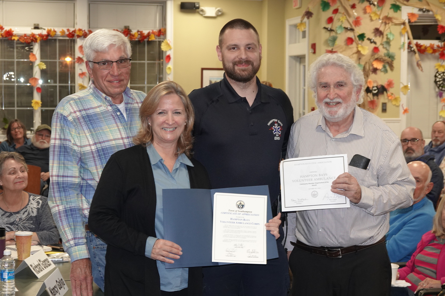 The Hampton Bays Civic Association honored members of the Hampton Bays Volunteer Ambulance Corps as its persons of the month for October and Supervisor Maria Moore presented the ambulance personnel with a proclamation applauding their dedication to the wellbeing of the people of Hampton Bays.