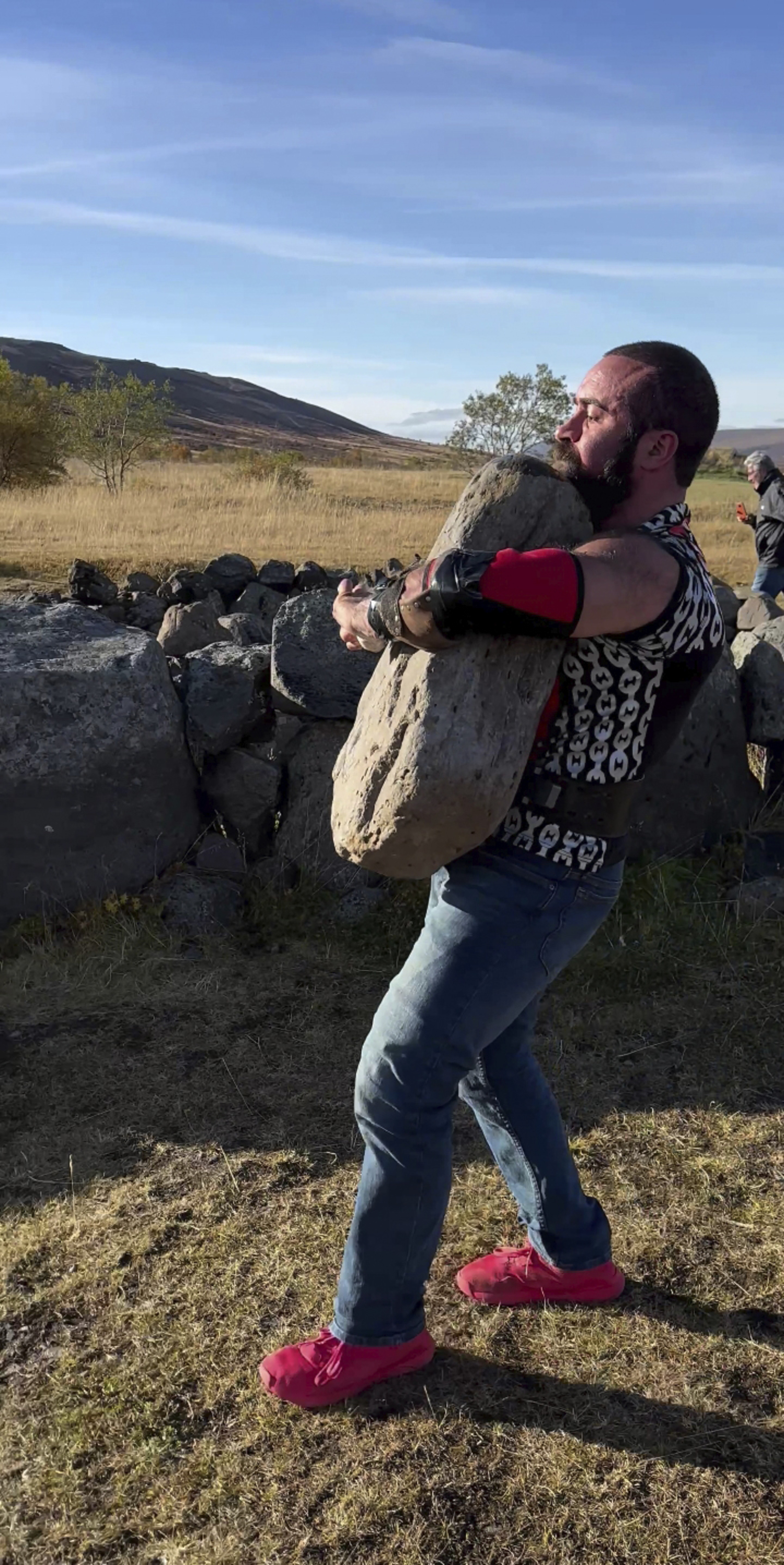 Cristian Candemir lifts and carries the Húsafell Stone in Húsafell, Iceland, this past September.