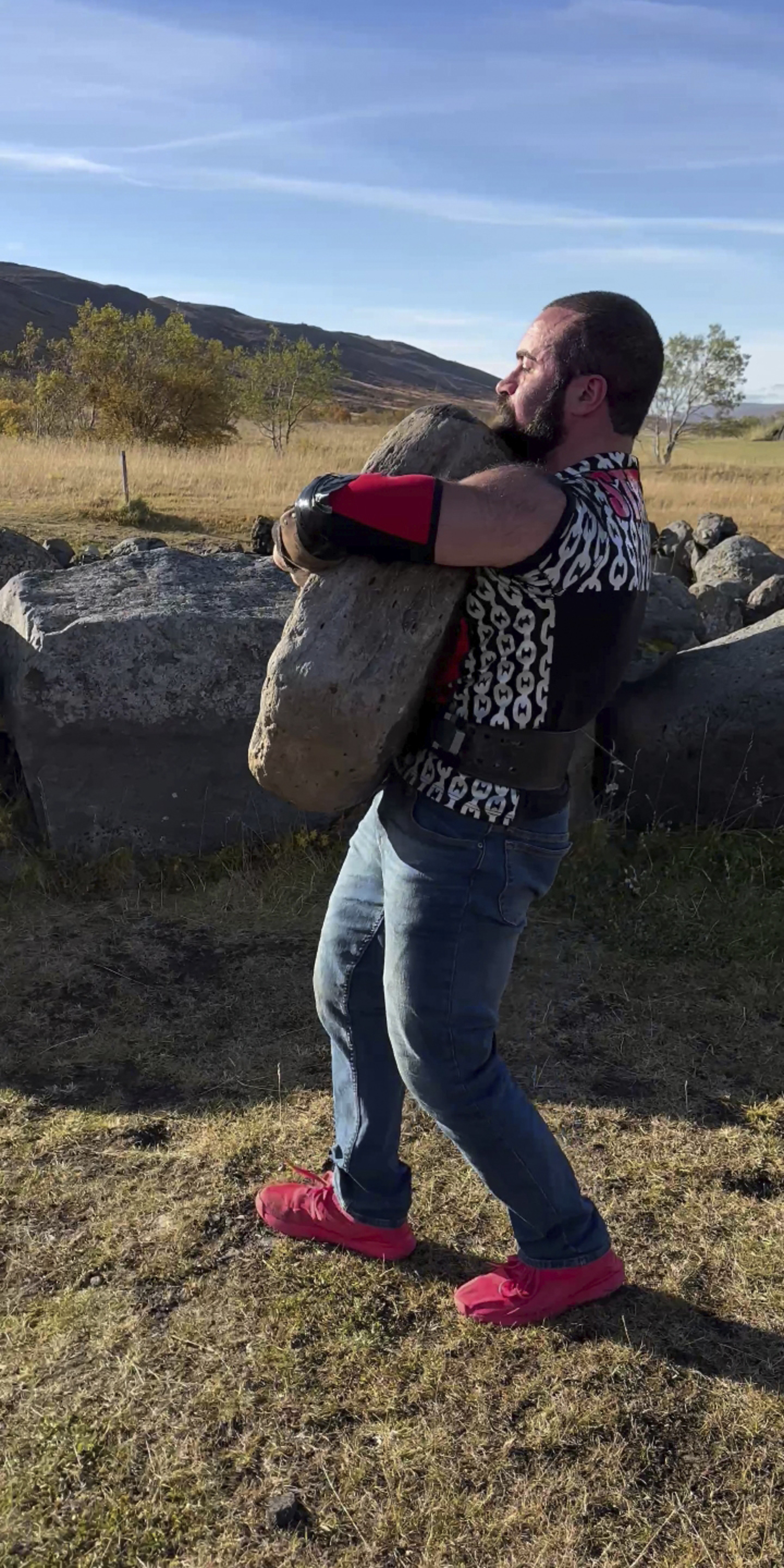 Cristian Candemir lifts and carries the Húsafell Stone in Húsafell, Iceland, this past September.