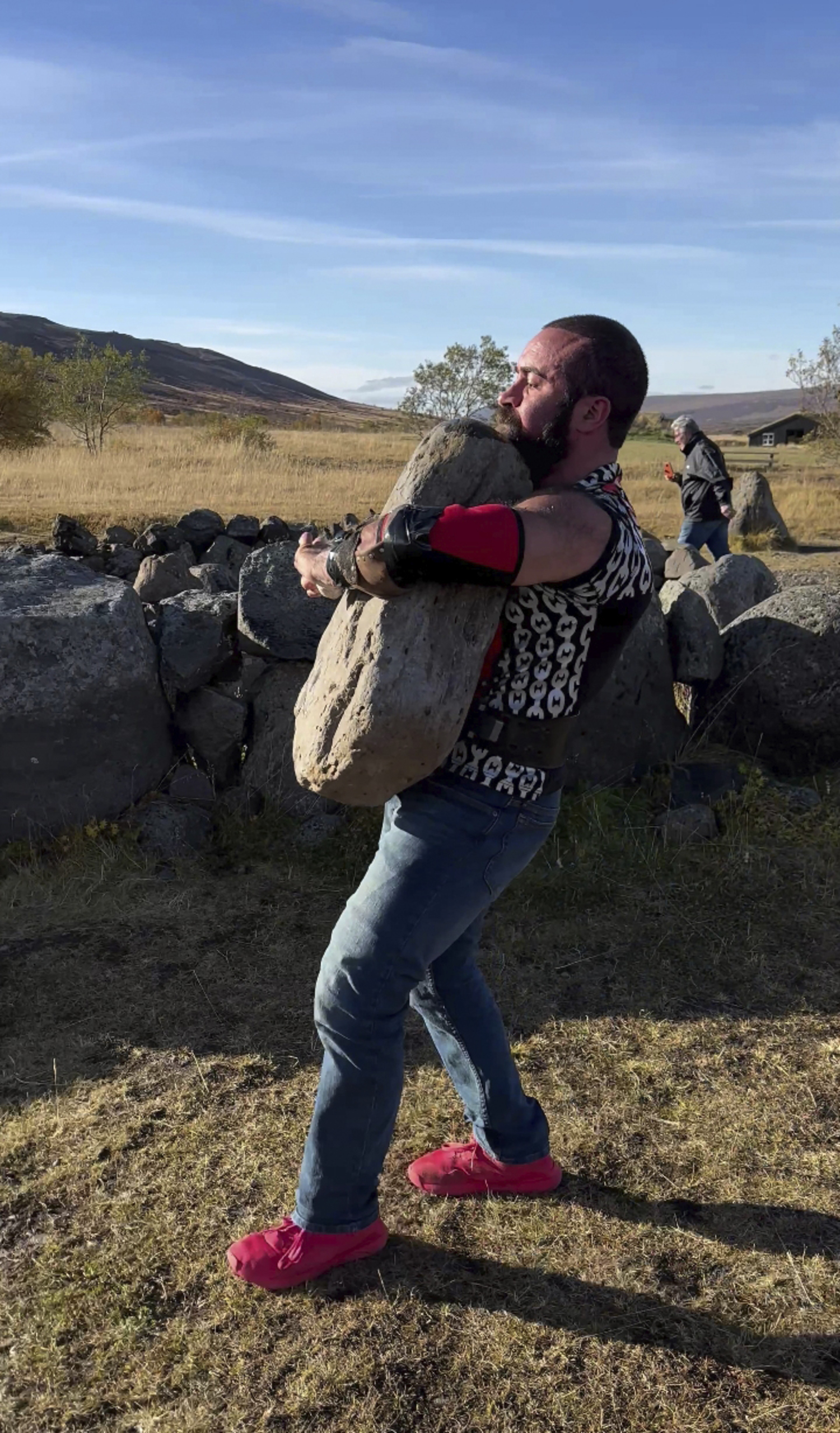 Cristian Candemir lifts and carries the Húsafell Stone in Húsafell, Iceland, this past September.