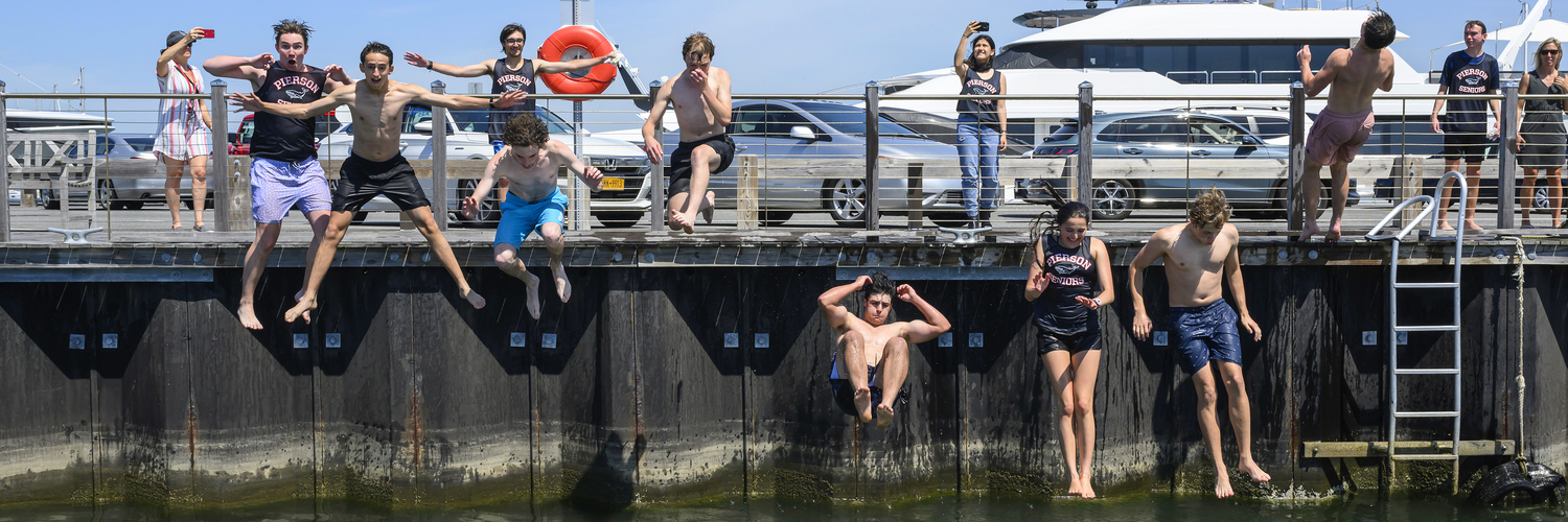 June 20 - Seniors at Pierson High School continue a tradition as they jump off the end of Long Wharf on June 13, as part of Senior Day. The Class of 2024 will receive diplomas at Commencement on June 29. MARIANNE BARNET