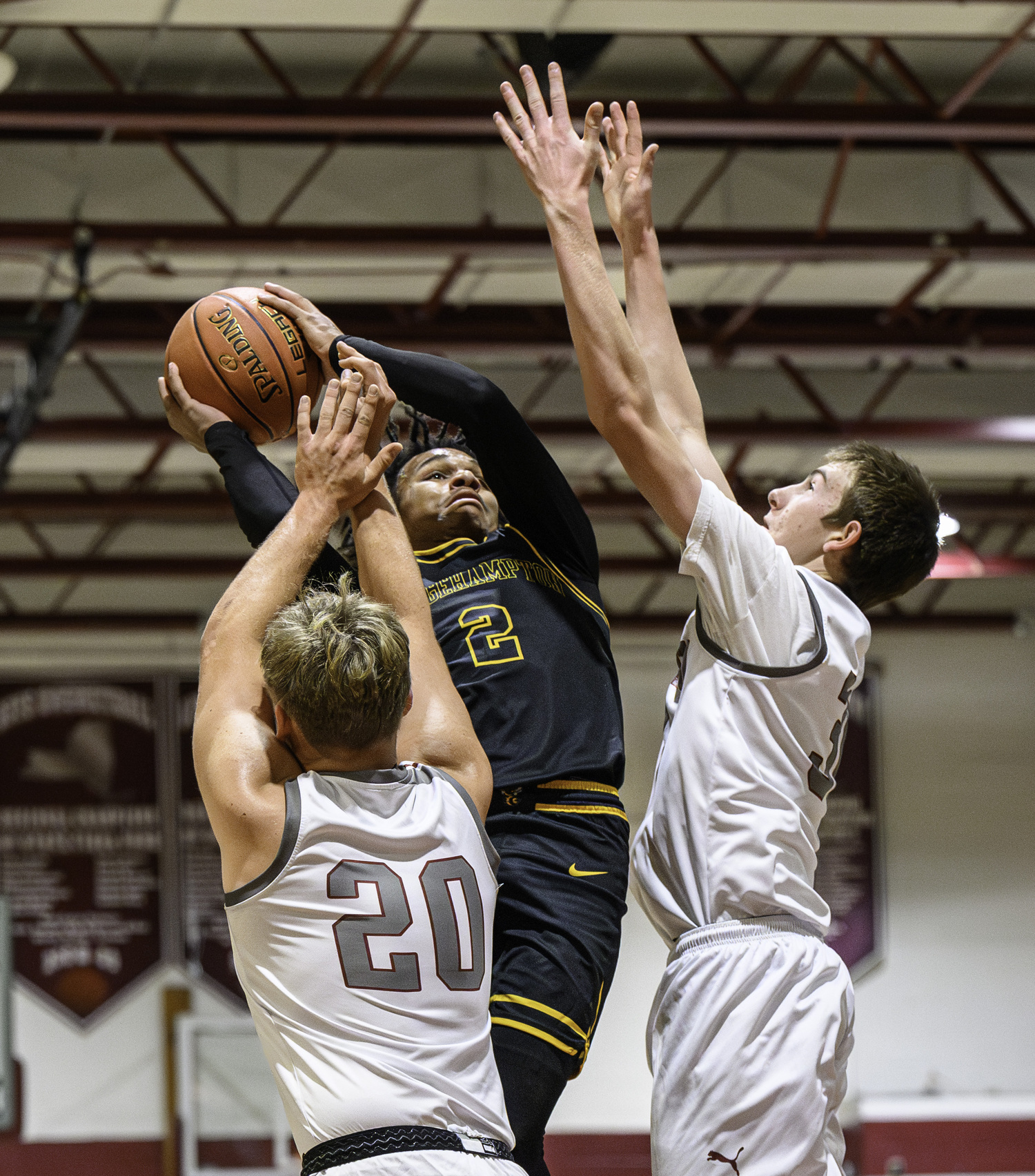 Bridgehampton junior Jai Feaster takes on a pair of East Hampton defenders.   MARIANNE BARNETT