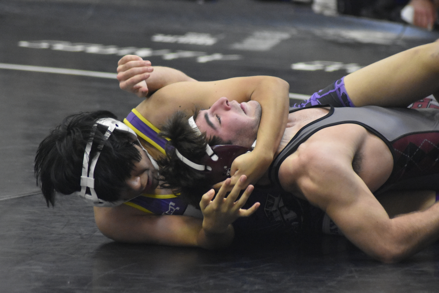 Hampton Bays senior Raul Lopez Ramirez tries to pin East Hampton senior Justin Prince.   DREW BUDD