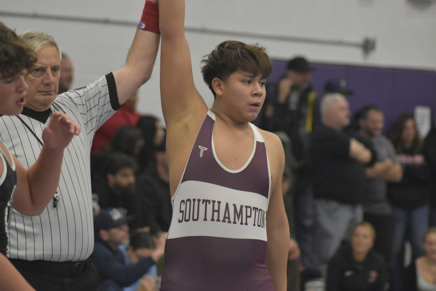 Southampton's Cruz Espinosa gets his arm raised after defeating Constantine Reilly of Westhampton Beach.   DREW BUDD