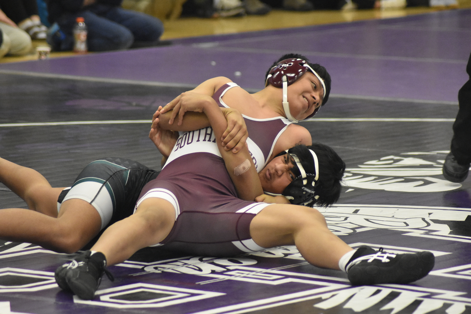 Fredy Chacon takes his Westhampton Beach opponent down to the mat in their JV match on Saturday.  DREW BUDD